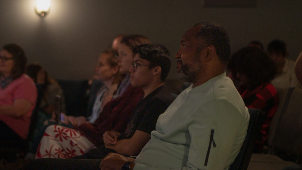 Diverse group of people smiling while listening to a Sunday morning message